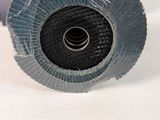 someone is holding a grinding wheel in their hand on a table