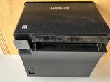 an image of a black printer sitting on a counter