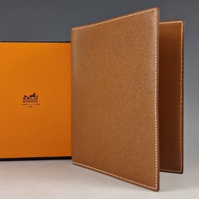the inside of a brown leather wallet with an orange cover