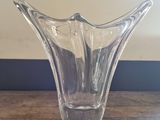 a glass vase that is sitting on a wooden table