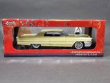 an old model of a yellow car in a red box