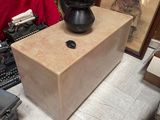 a black vase sitting on top of a wooden box