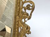 a mirror that is sitting on the floor in front of a brick wall