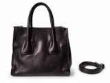 a black handbag with a leather strap on a white background
