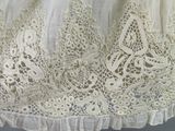 a close up of a white dress with lace on it