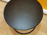 a black table with a black top on a wooden floor