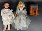 two dolls sitting next to each other on a table