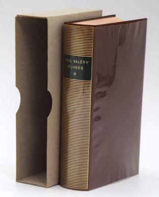 a book in a cardboard box with a brown cover