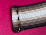 a black and white striped belt on a pink surface