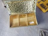 a gold box with scissors and a pair of scissors on the table