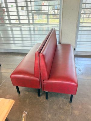 a red leather bench in the middle of a room