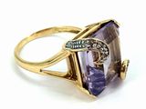 a close up of a ring with an amethorate and diamonds