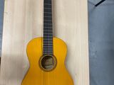 an acoustic guitar hanging on a wall in a room
