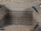a wicker basket that has a handle on it