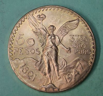 an image of a coin with an angel on it on a green surface