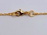 a close up of a gold chain bracelet with three stones on it