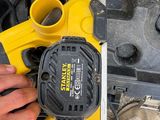 the man is using a power tool to cut a hole in the side of a vehicle