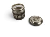 a silver container with a coin inside of it on a white surface