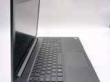 a laptop computer sitting on a table with a keyboard