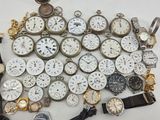 many different types of watches sitting on a table