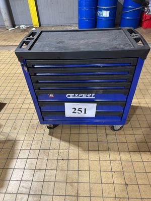 a blue tool box sitting on top of a tiled floor