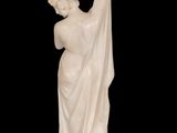 a white marble statue of a woman holding a flower
