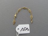a gold bracelet with a tag that says aol on it