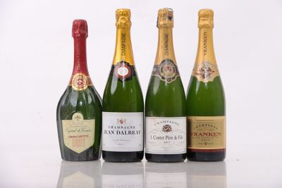 four bottles of champagne are lined up in a row