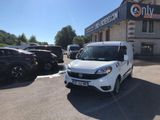 the white van is parked in front of a building with a sign on it