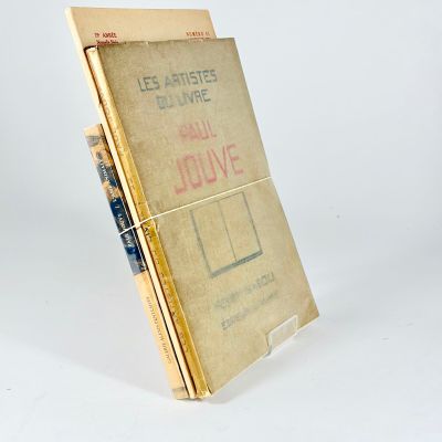 books are stacked on top of each other on a white surface