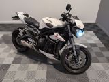 a white and black motorcycle parked on a checkered floor