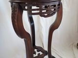 a wooden table with a vase on top of it