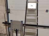 a ladder that is leaning against a garage door