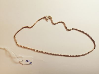 a gold necklace with a chain that is attached to it