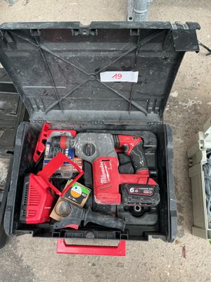 a tool box with tools in it sitting on the ground