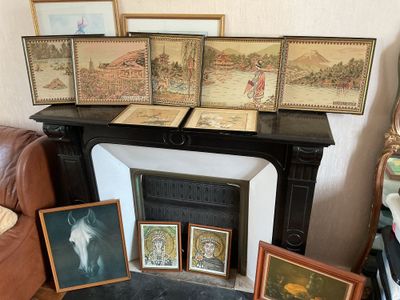 many framed pictures on the mantle in this living room