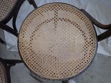 a chair that has a wicker seat on top of it