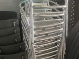a lot of chairs that are stacked up in a room