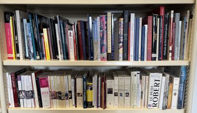 a bookshelf with many books on it in a room
