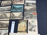 an old photo of a bunch of old postcards sitting on a table