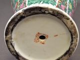 a close up of a vase with flowers on it