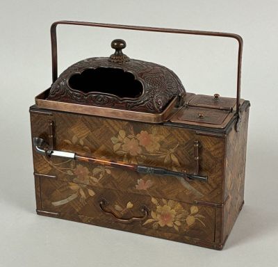 a small wooden box with a handle and a lid