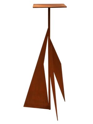 an image of a metal sculpture of a sailboat on a table