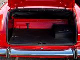 a red car with its trunk open in a parking lot
