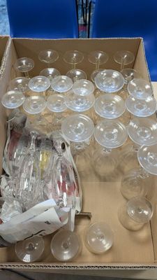 a box of empty wine glasses sitting on a table