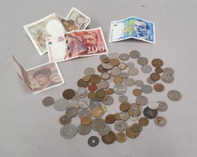 a pile of coins and money on a table