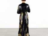 a black and gold statue of a man in a robe