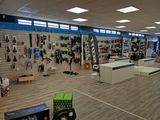 a store with a lot of skis and snowboards on the wall