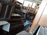 a room filled with lots of wooden furniture and boxes