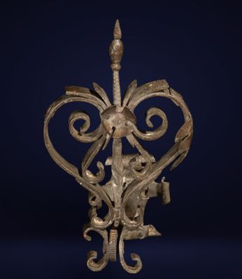 an old iron lamp with a decorative design on a dark blue background